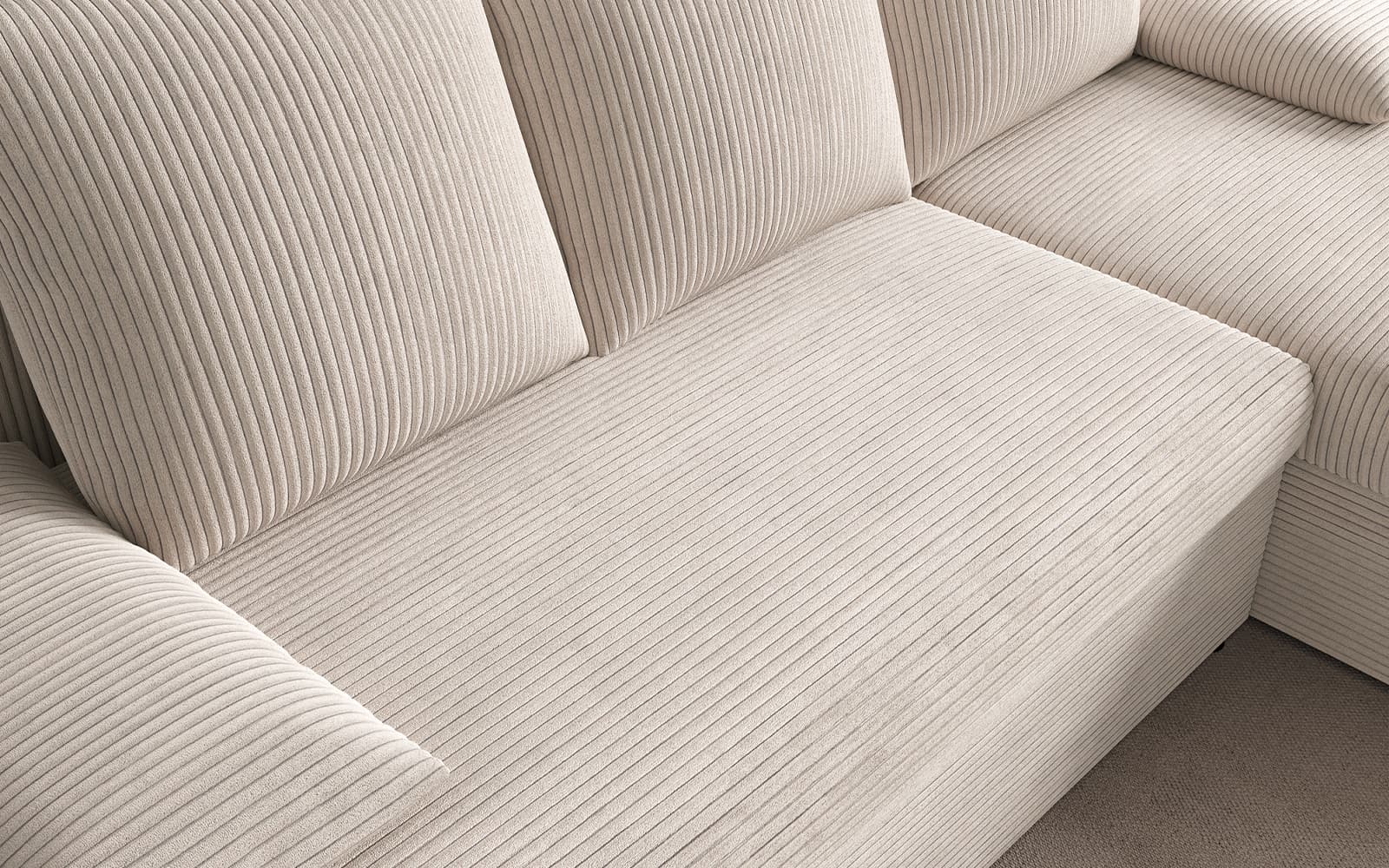 Close-up of a beige ribbed fabric sofa with padded seat and back cushions, showing vertical stripe texture.