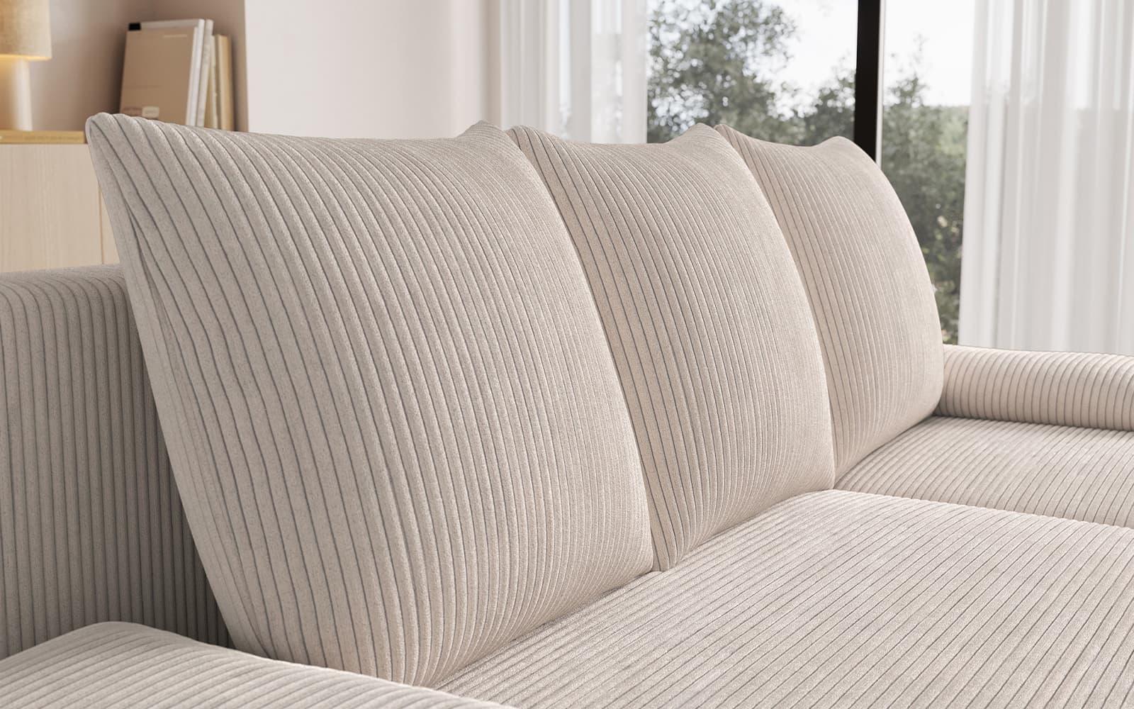 Beige corded fabric sofa with ribbed cushions in a bright living room setting.