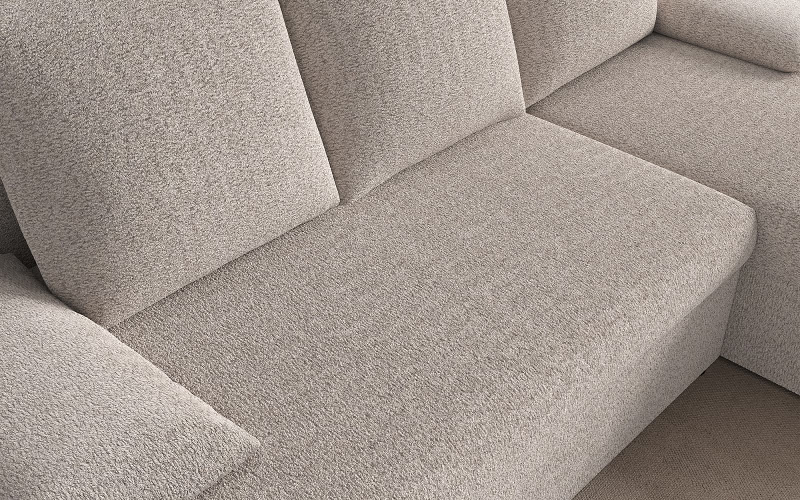 Close-up of a beige textured fabric sectional sofa with cushions and a corner chaise.