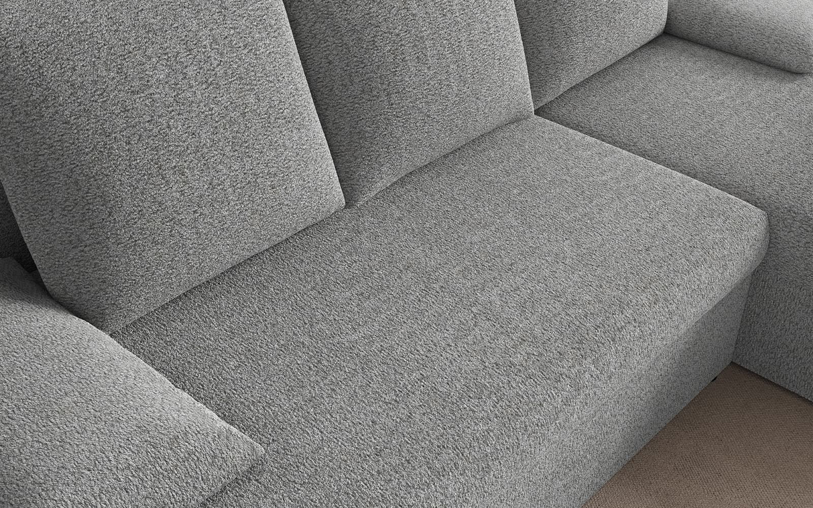Close-up of a gray textured fabric sofa with cushions and a corner seat joining two sections]("1")}{