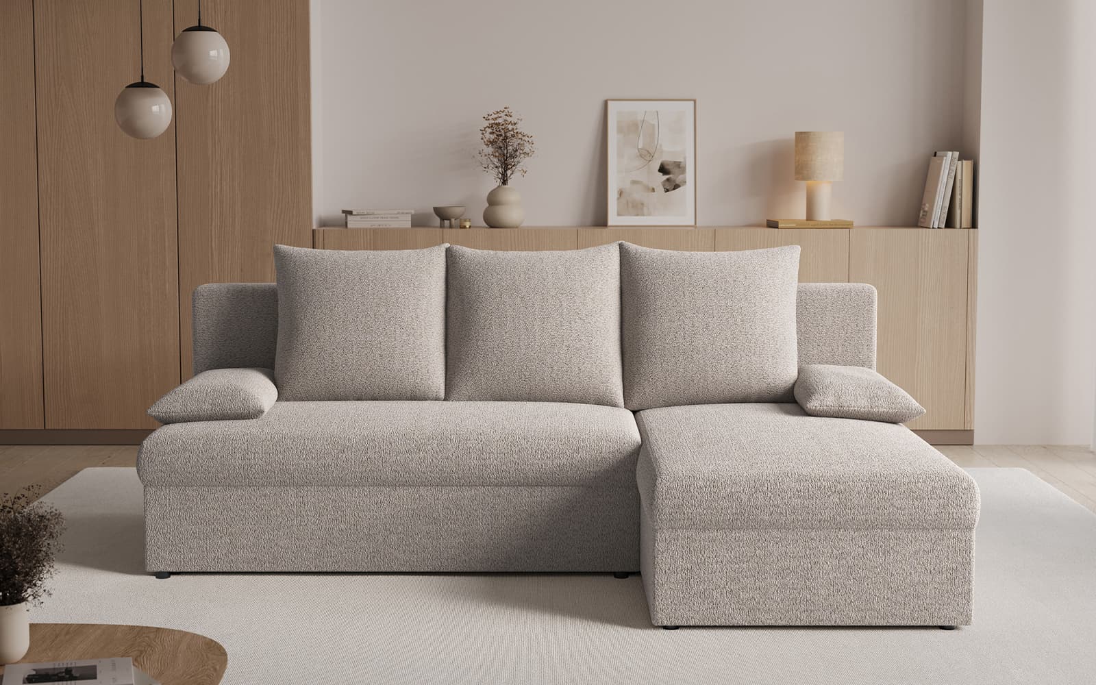 Light grey L-shaped sofa in a minimalist living room with wooden cabinets and neutral decor.